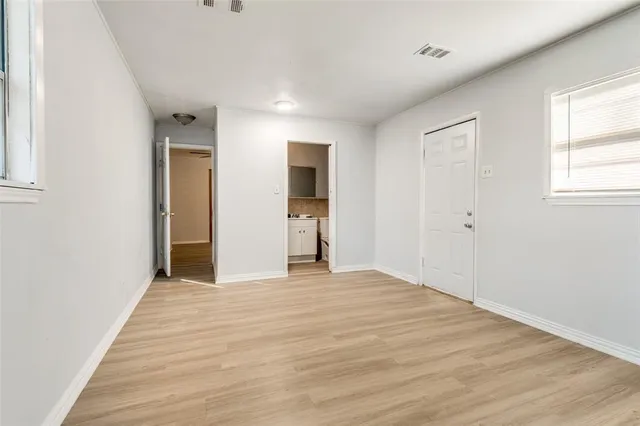 a view of empty room with wooden floor