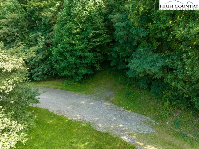 a backyard of a house with a yard and potted plants
