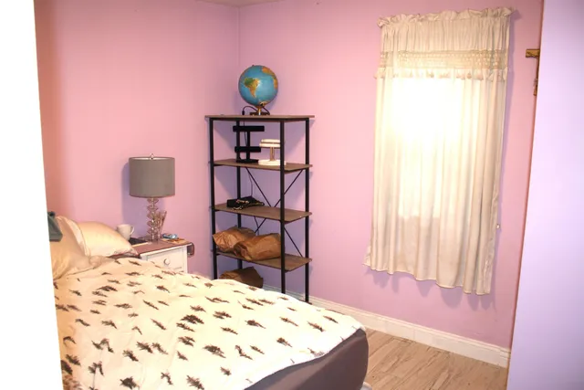 a bedroom with a bed and a window