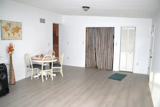 a dining room with furniture and wooden floor