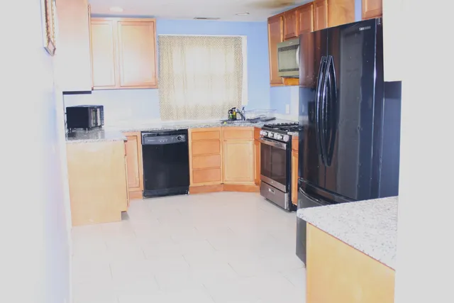 a kitchen with a refrigerator sink and stove