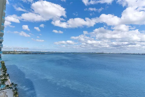 a bedroom with a large bed and a large window