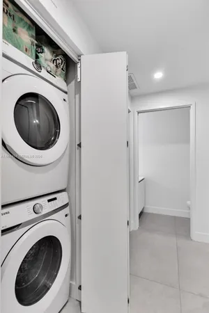 a dining room with furniture and a flat screen tv