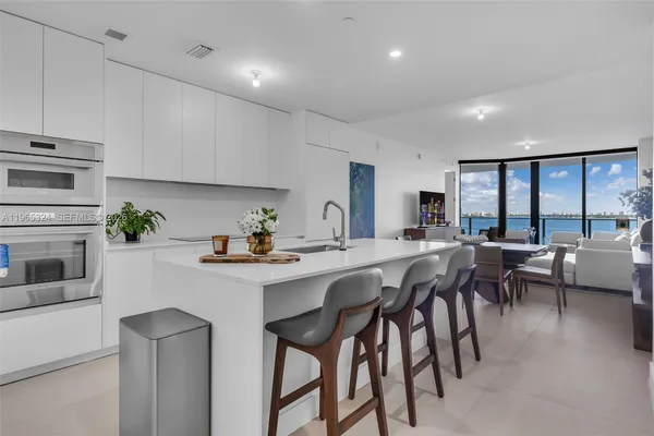 a kitchen with cabinets table and chairs