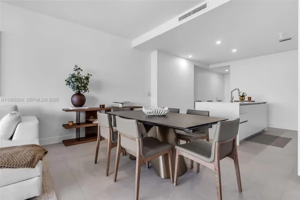 a view of a dining room with furniture and a potted plant