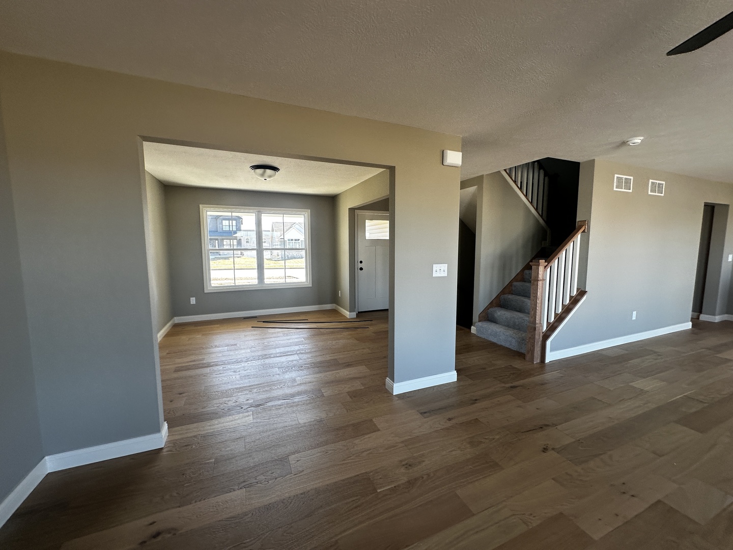 1710 Bluestone Drive Normal, IL 61761 - Photo 6 of 18 a view of an empty room with wooden floor and a window