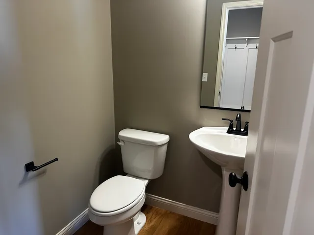 a bathroom with a sink toilet and a mirror