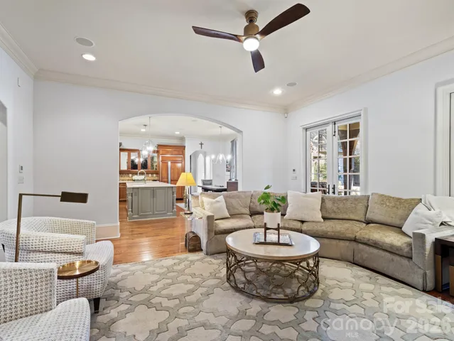 a living room with furniture and a chandelier