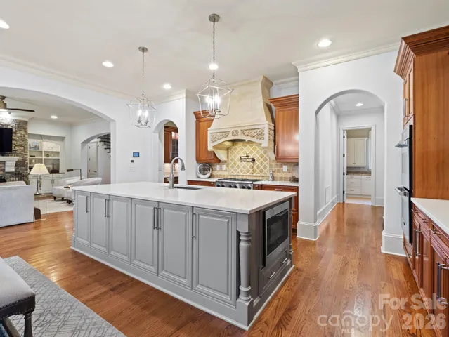 a large kitchen with a large island in the center and living room