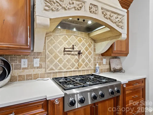 a kitchen with a stove and a cabinets