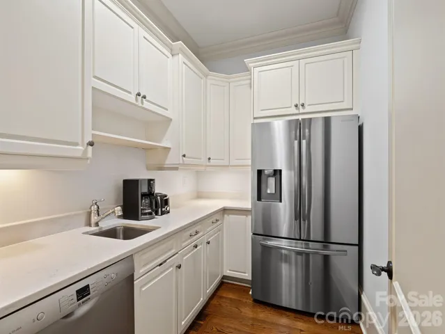 a white refrigerator freezer sitting inside of a kitchen