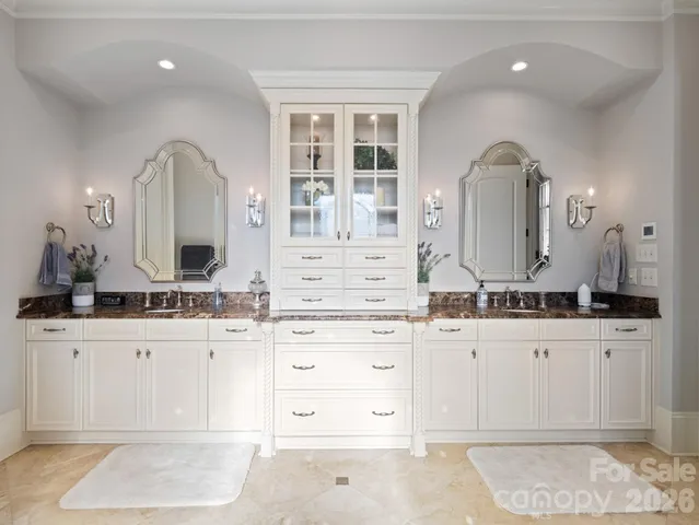 a bathroom with a sink vanity and mirror