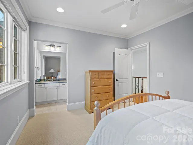 a bedroom with a bed and a view of kitchen
