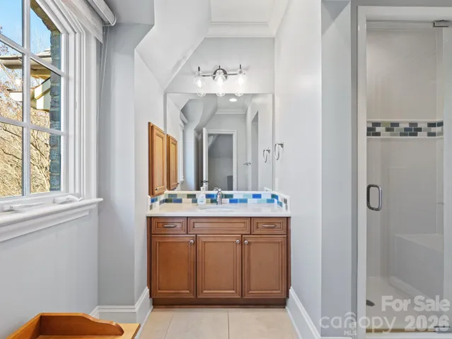 a bathroom with a double vanity sink and a mirror