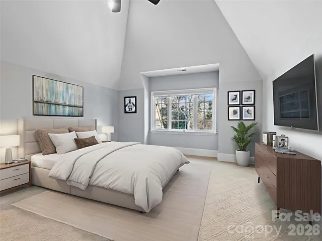 a bedroom with a balcony a large bed and a window