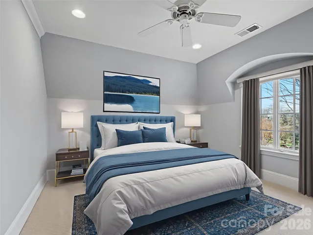 a bedroom with bed and a chandelier