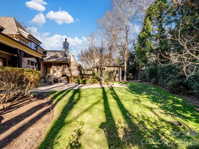 a view of yard with swimming pool and seating