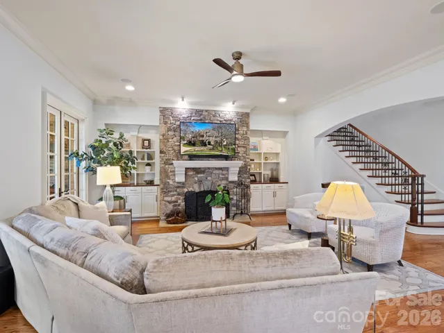 a living room with fireplace furniture and a chandelier