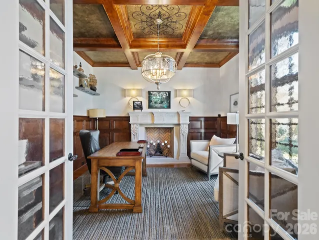 a view of a dining room with furniture a chandelier and wooden floor