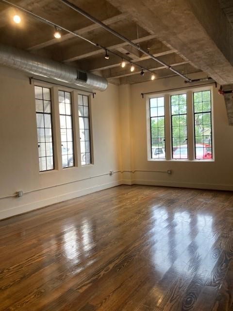 4411 Dallas Street, Unit 1 Houston, TX 77023 - Photo 3 of 13 a view of an empty room with wooden floor and a window