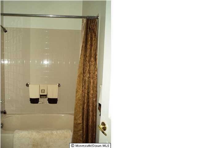 8 Riva Boulevard Brick, NJ 08723 - Photo 10 of 12 a bathroom with a shower
