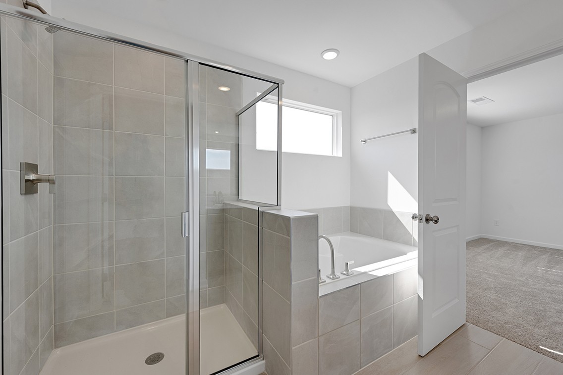 199 East Millbrook Drive Spring Hill, TN 37174 - Photo 19 of 32 a bathroom with a bathtub and a shower