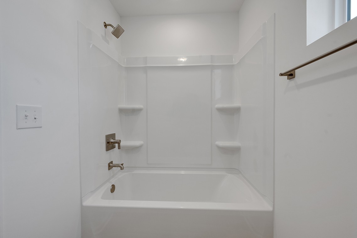 199 East Millbrook Drive Spring Hill, TN 37174 - Photo 26 of 32 a white bath tub sitting next to a white sink and vanity