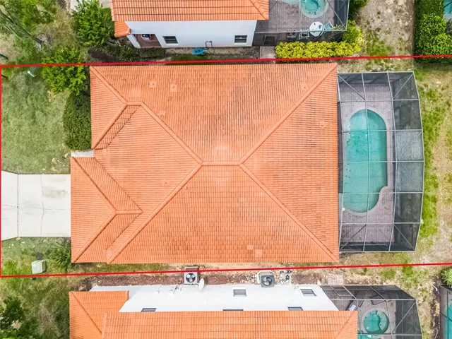 an aerial view of residential houses with outdoor space and swimming pool