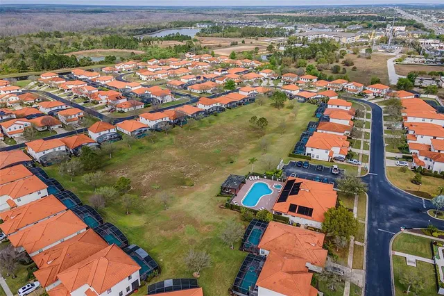 an aerial view of residential houses with outdoor space and river