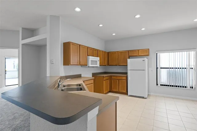 a kitchen that has a sink and a stove in it