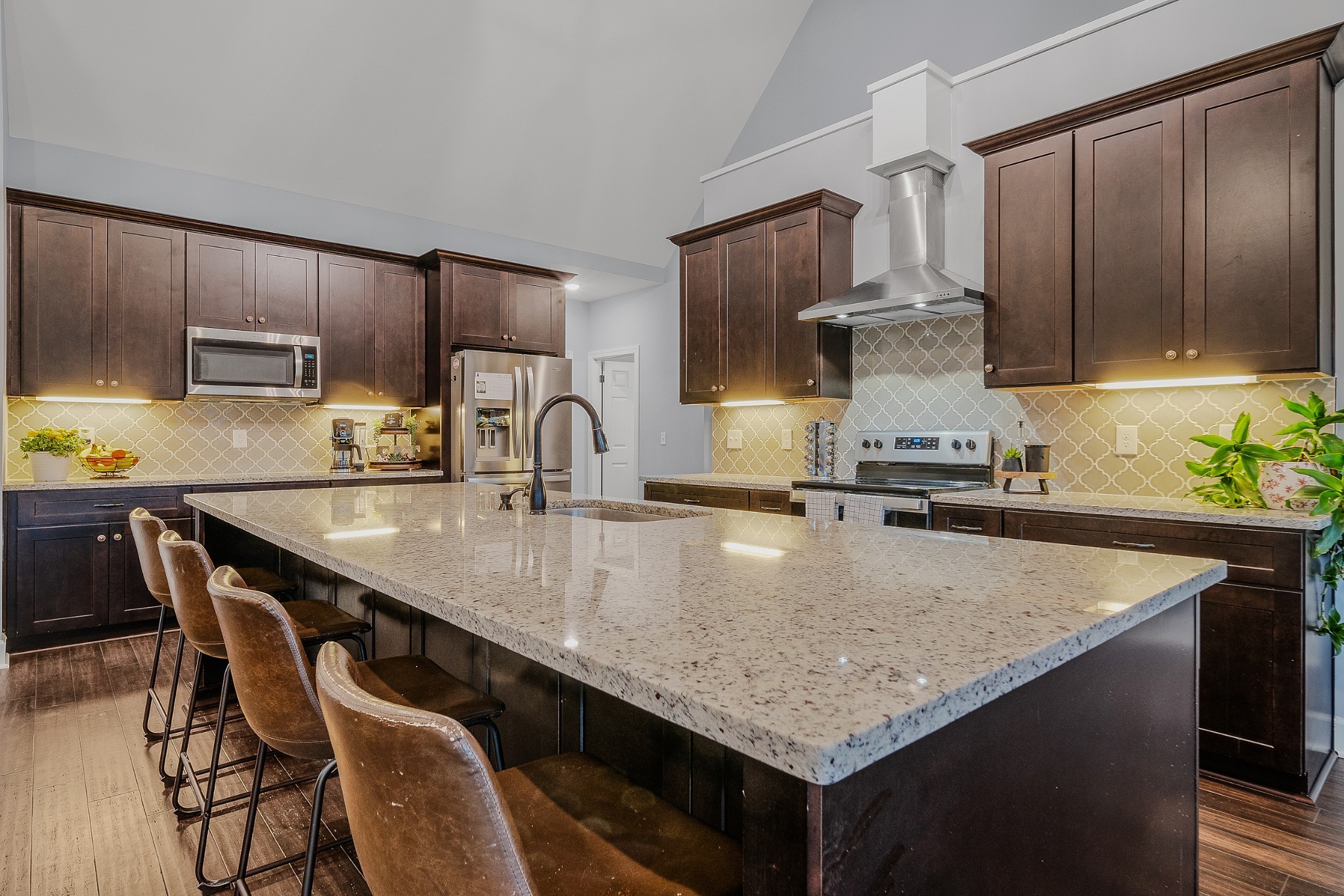 7998 Miller Road Christiana, TN 37037 - Photo 11 of 43 a kitchen with kitchen island granite countertop a sink chairs and refrigerator