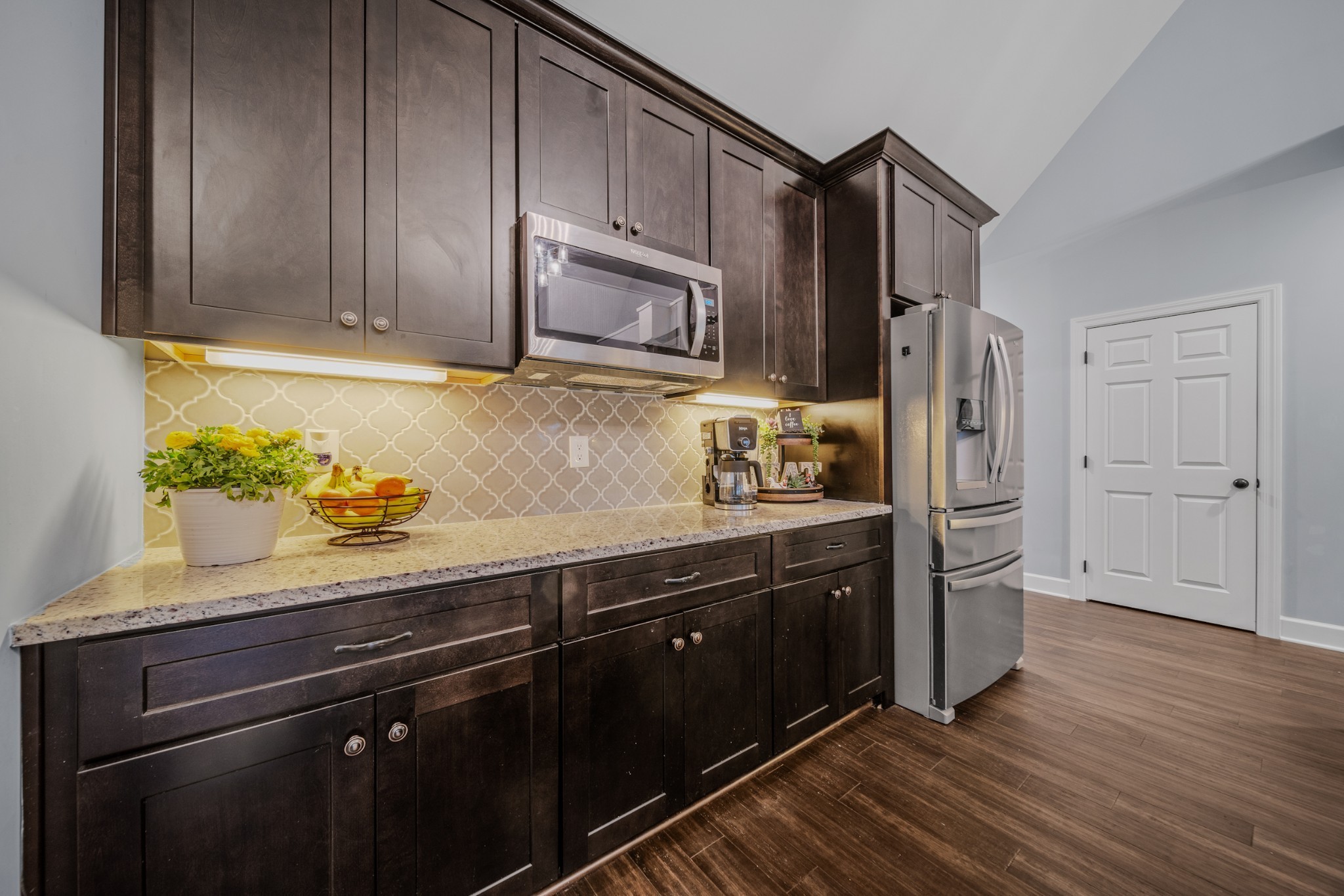 7998 Miller Road Christiana, TN 37037 - Photo 12 of 43 a kitchen with granite countertop wooden cabinets and stainless steel appliances