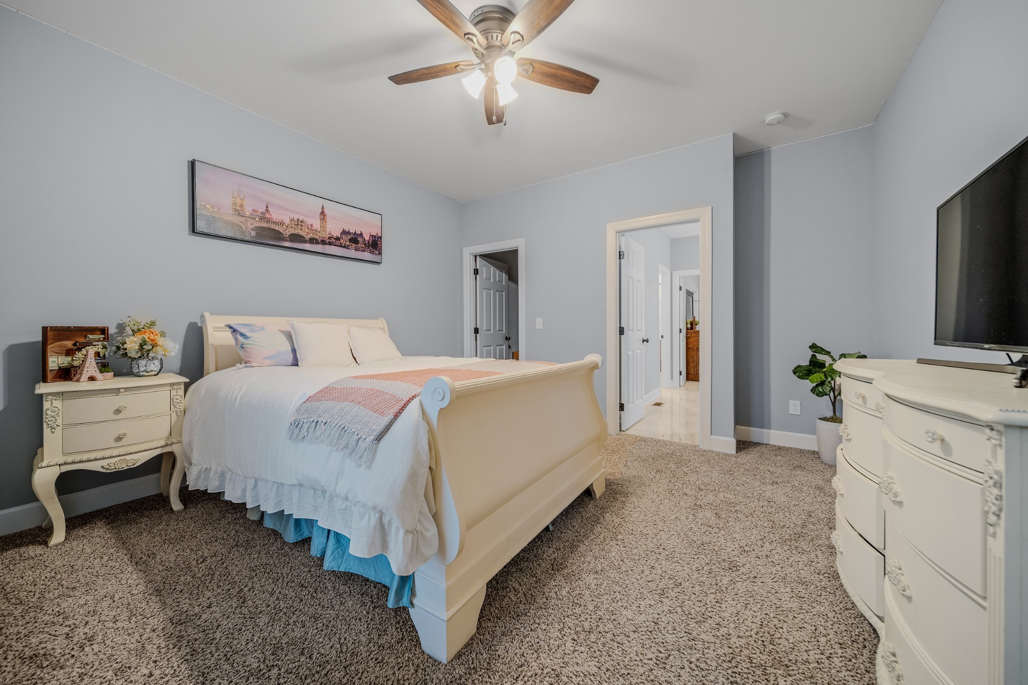 7998 Miller Road Christiana, TN 37037 - Photo 23 of 43 a spacious bedroom with a bed and a flat tv screen on dresser