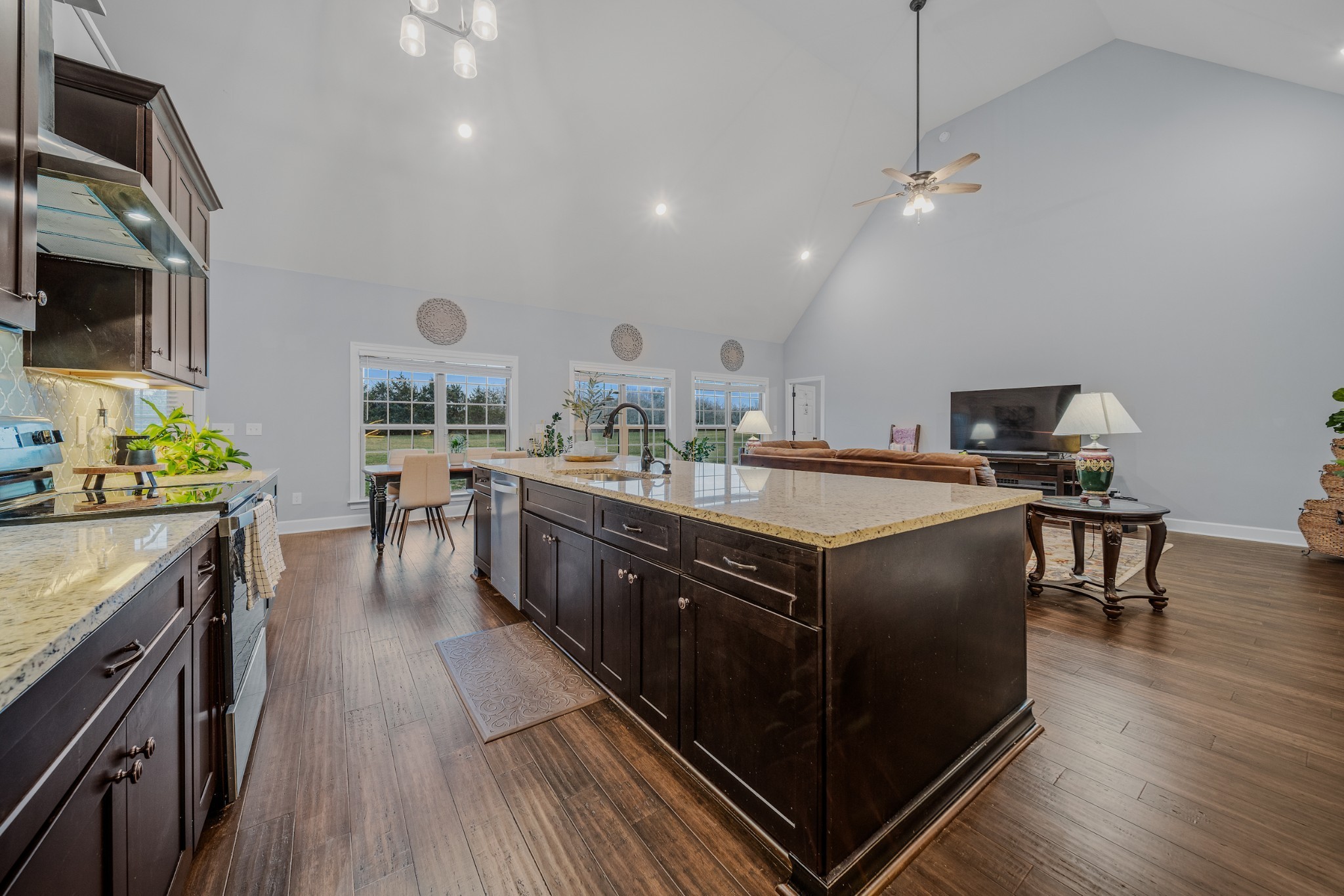 7998 Miller Road Christiana, TN 37037 - Photo 8 of 43 a kitchen with stainless steel appliances granite countertop a sink a stove and a wooden floors