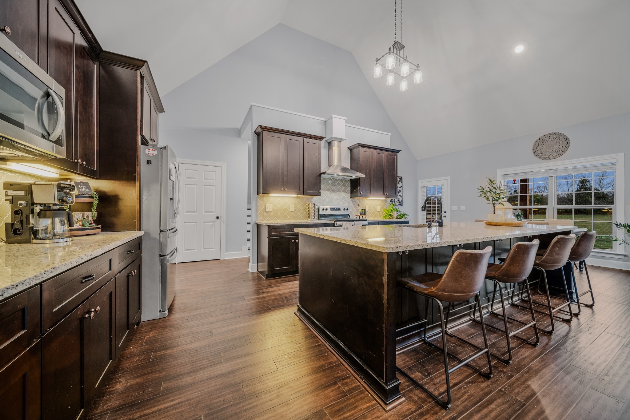 7998 Miller Road Christiana, TN 37037 - Photo 10 of 43 a kitchen with stainless steel appliances granite countertop a refrigerator a stove top oven a sink dishwasher and white cabinets with wooden floor
