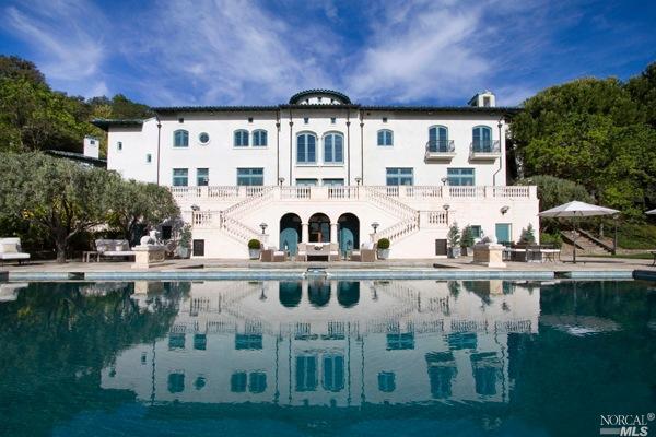 a front view of a building with lake view and sitting space