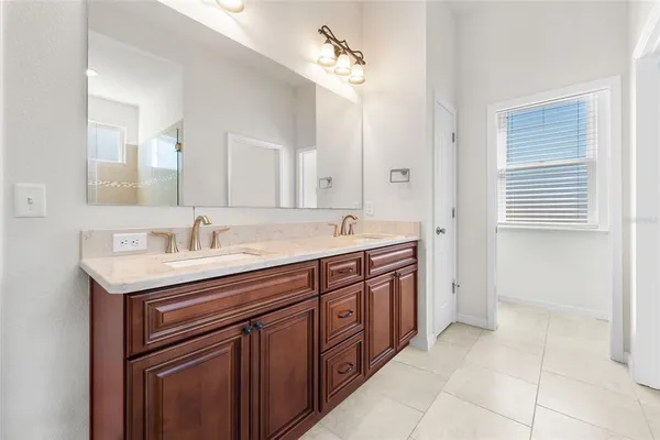 a spacious bathroom with a granite countertop sink and a mirror