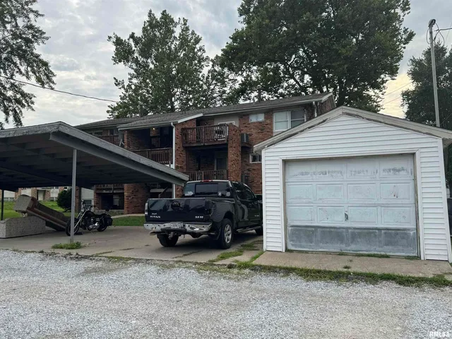 a view of a car park in front of house