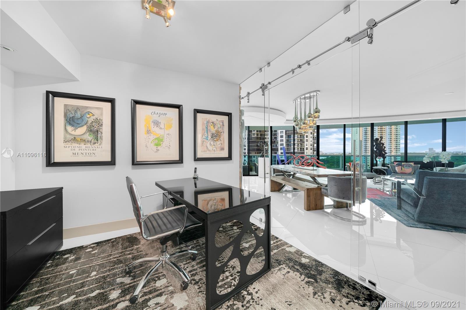 2127 Brickell Avenue, Unit 1602 Miami, FL 33129 - Photo 12 of 40 a living room with furniture and a large window