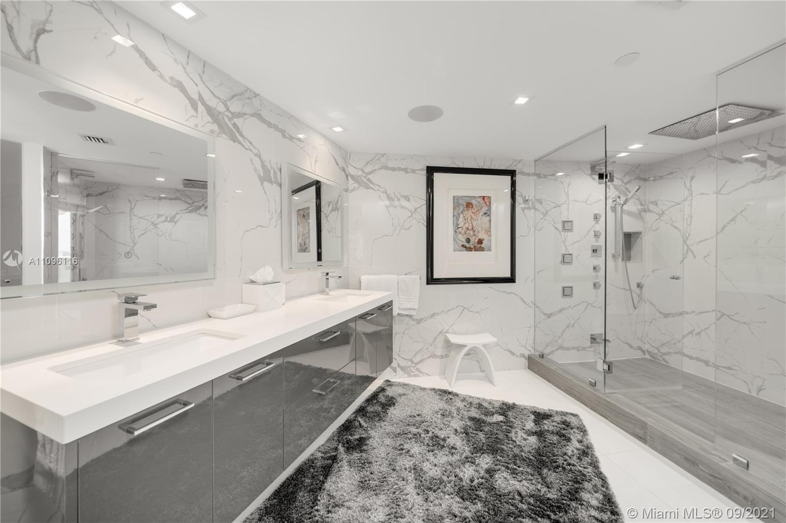 2127 Brickell Avenue, Unit 1602 Miami, FL 33129 - Photo 15 of 40 a bathroom with a double vanity sink mirror and shower