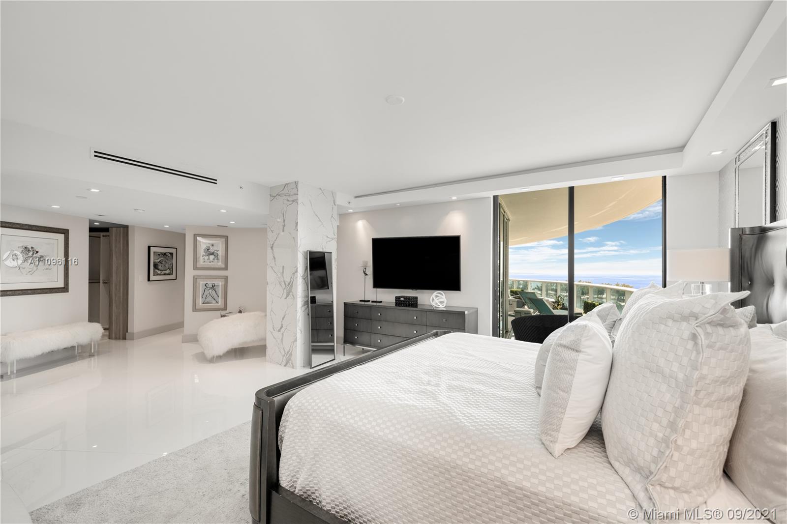 2127 Brickell Avenue, Unit 1602 Miami, FL 33129 - Photo 19 of 40 a bedroom with a bed and a flat screen tv