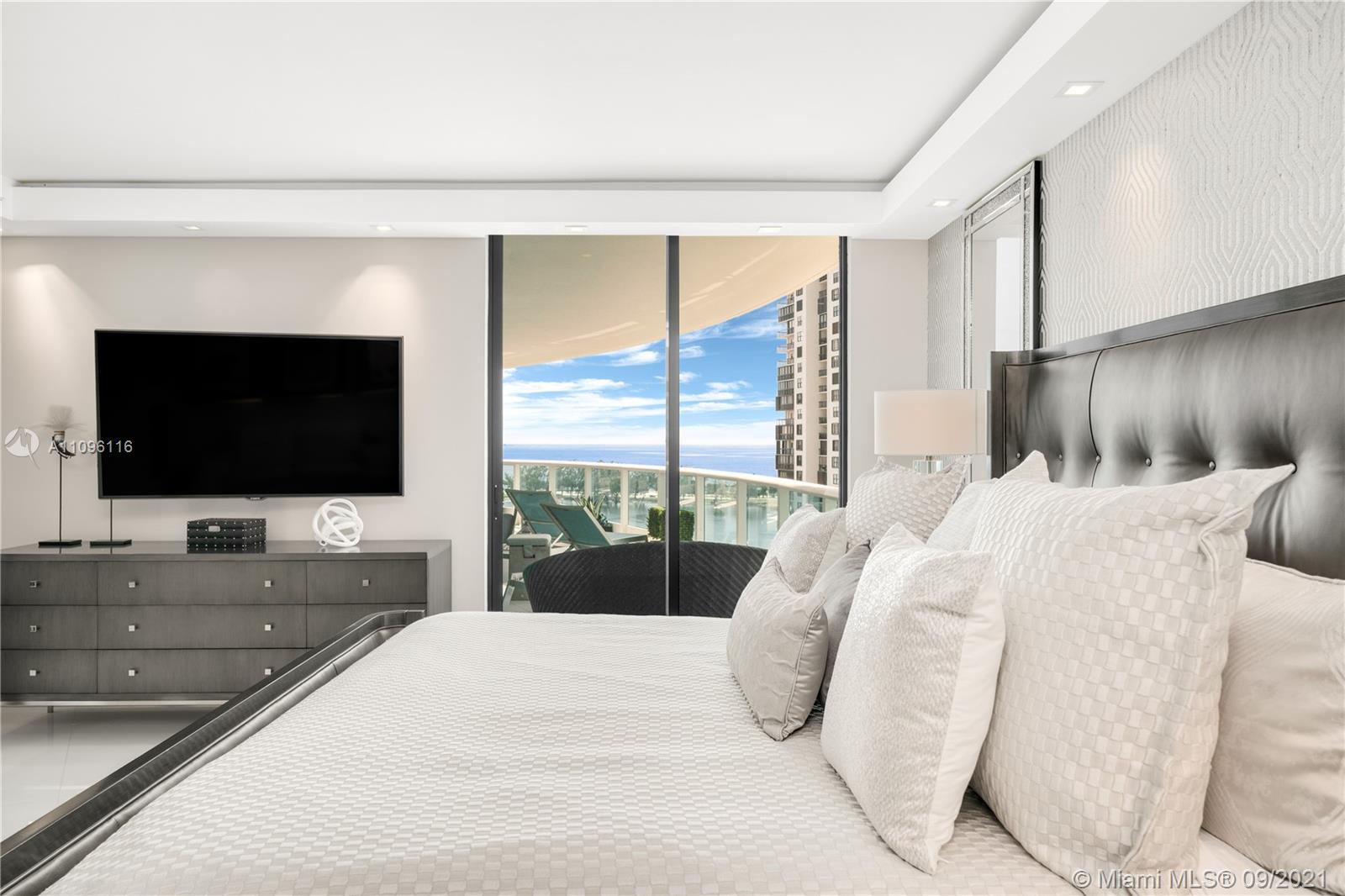 2127 Brickell Avenue, Unit 1602 Miami, FL 33129 - Photo 20 of 40 a bedroom with a bed and a flat screen tv