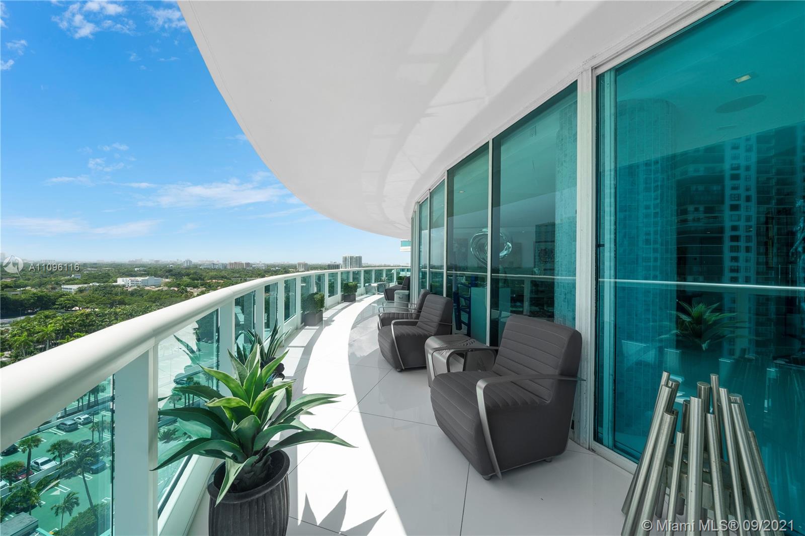 2127 Brickell Avenue, Unit 1602 Miami, FL 33129 - Photo 24 of 40 a balcony with potted plants and wooden floor