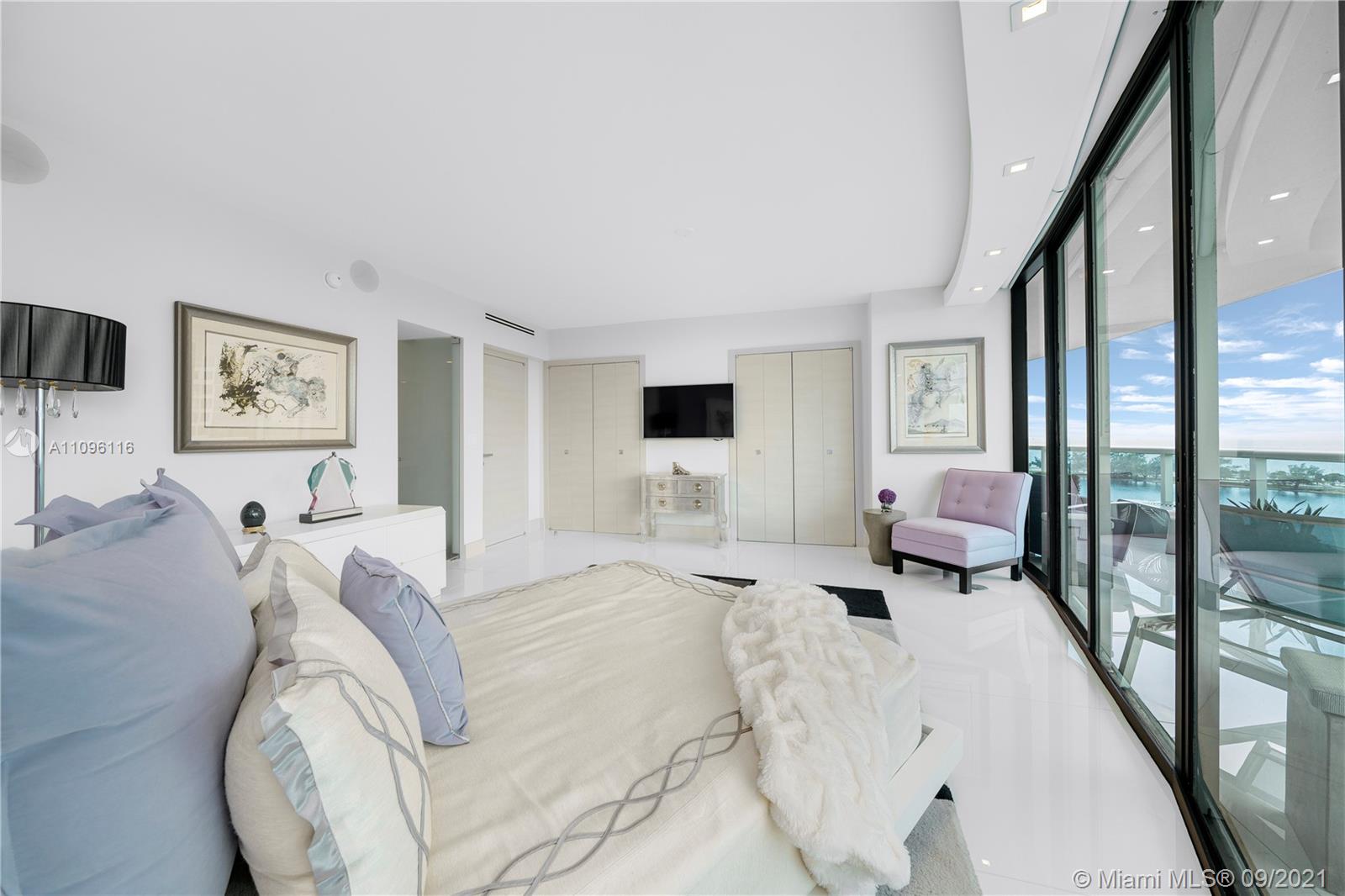 2127 Brickell Avenue, Unit 1602 Miami, FL 33129 - Photo 25 of 40 a spacious bedroom with a bed a couch and large window