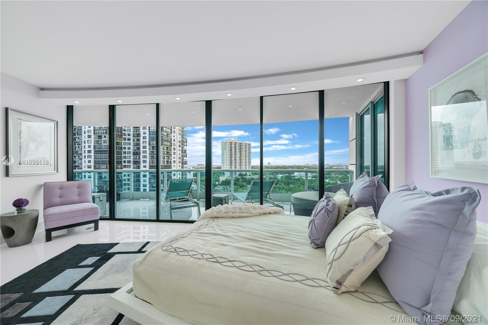 2127 Brickell Avenue, Unit 1602 Miami, FL 33129 - Photo 26 of 40 a bedroom with a bed and glass window