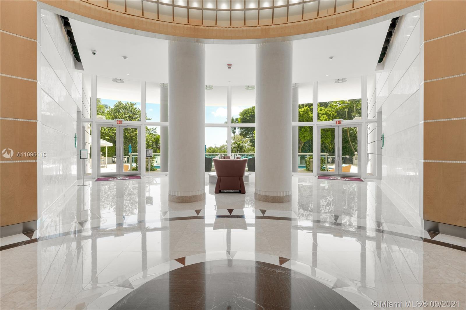 2127 Brickell Avenue, Unit 1602 Miami, FL 33129 - Photo 32 of 40 a living room with hardwood floor and windows