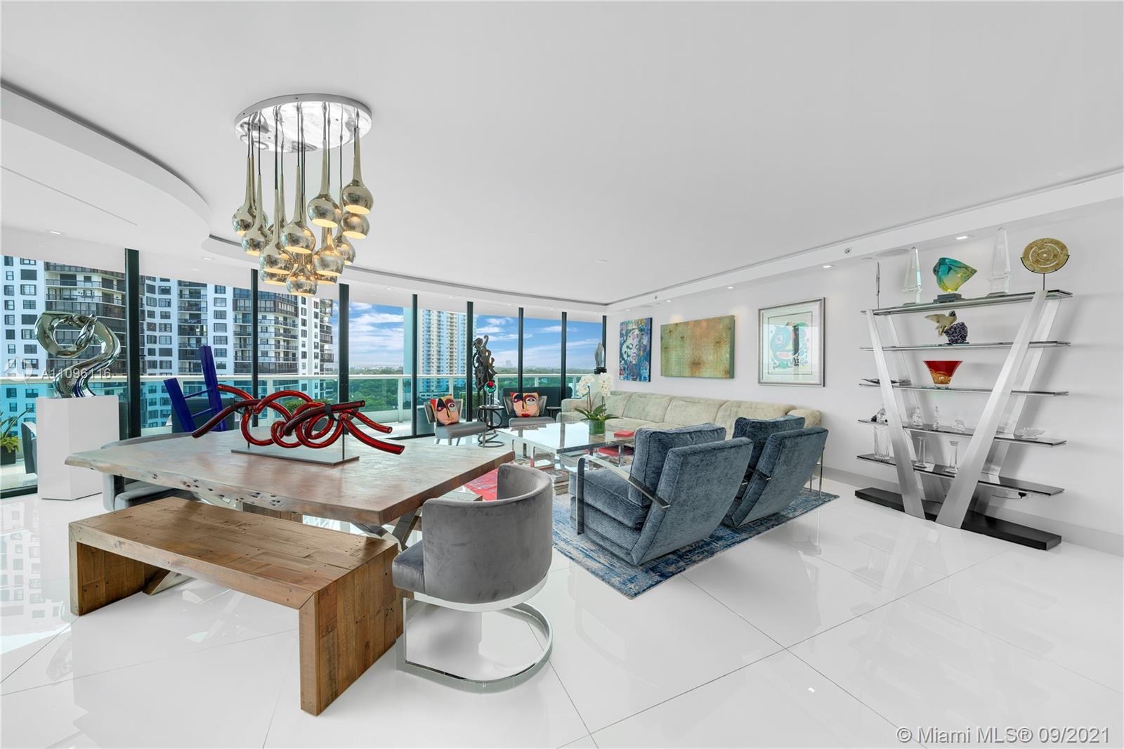 2127 Brickell Avenue, Unit 1602 Miami, FL 33129 - Photo 6 of 40 a living room with furniture a chandelier and a large window