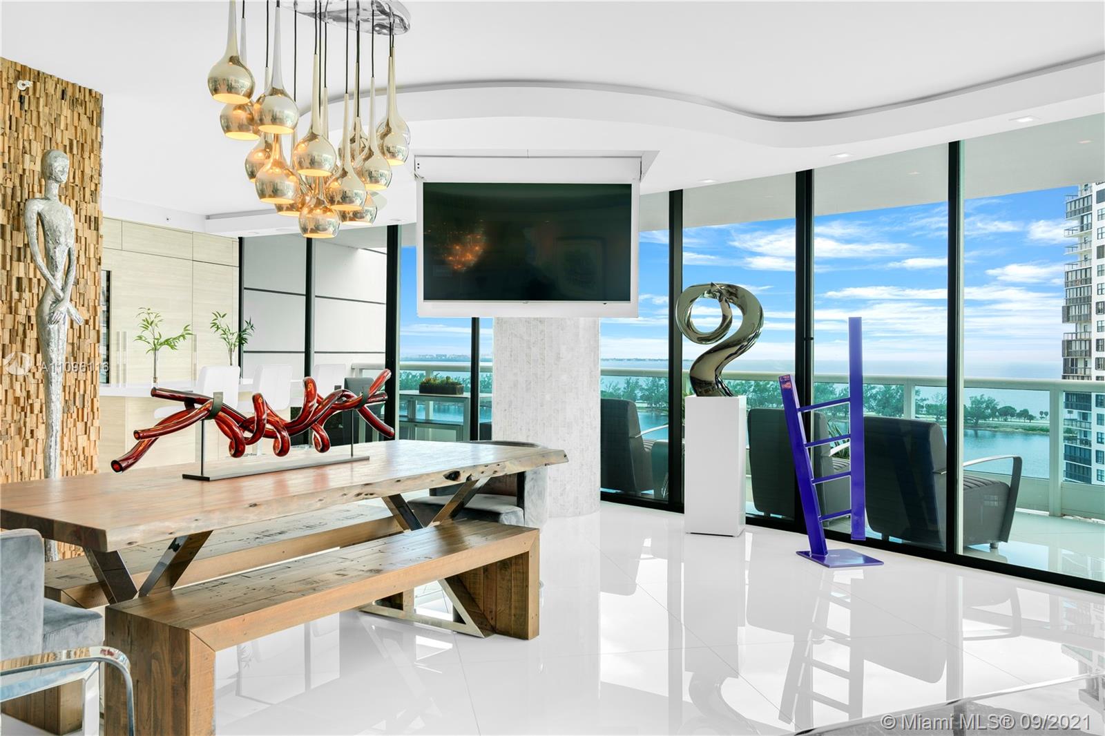 2127 Brickell Avenue, Unit 1602 Miami, FL 33129 - Photo 10 of 40 a living room view with fireplace and flat screen tv