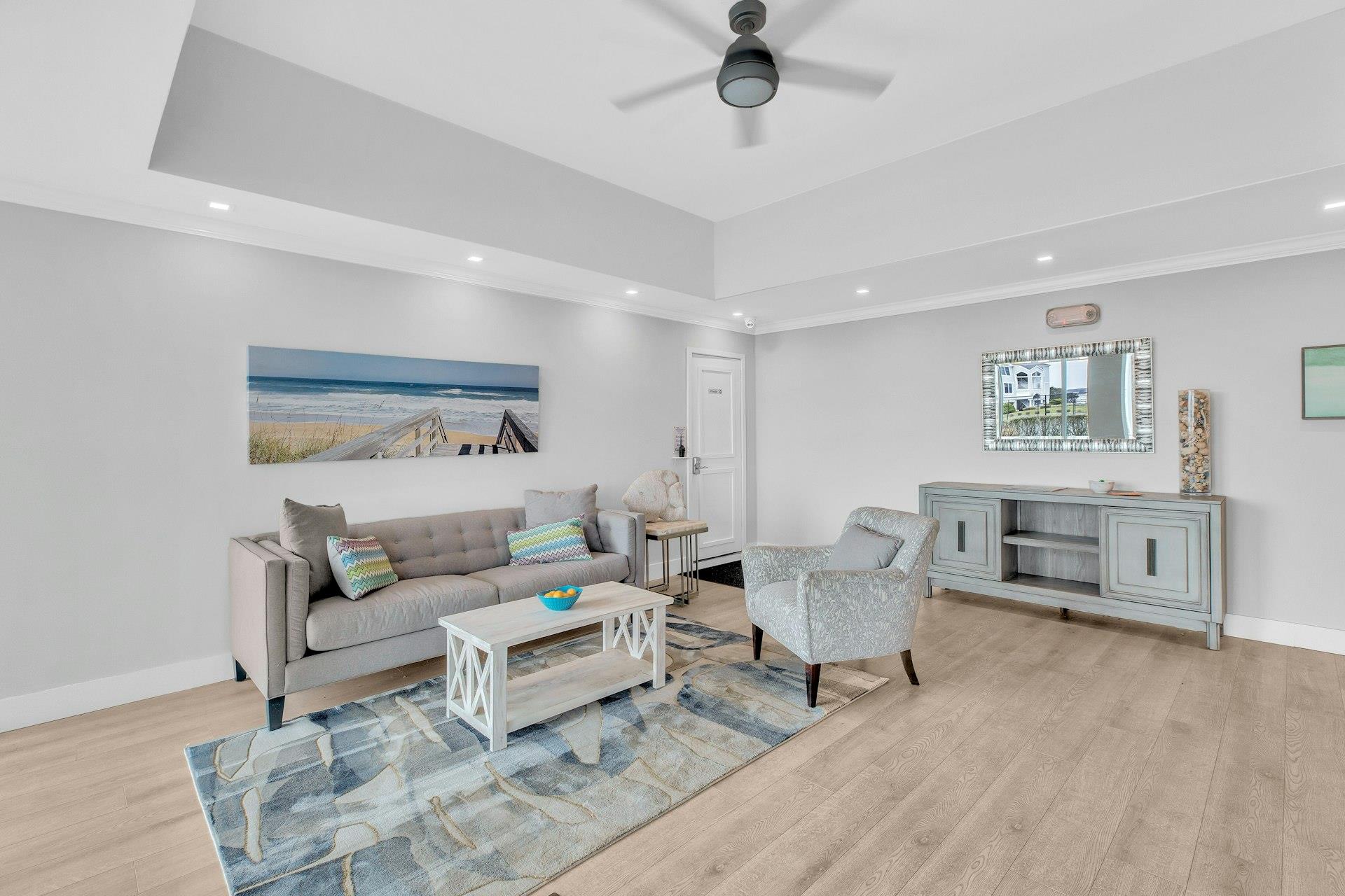 585 Dune Road, Unit L9 Westhampton, NY 11978 - Photo 3 of 20 a living room with furniture and a wooden floor