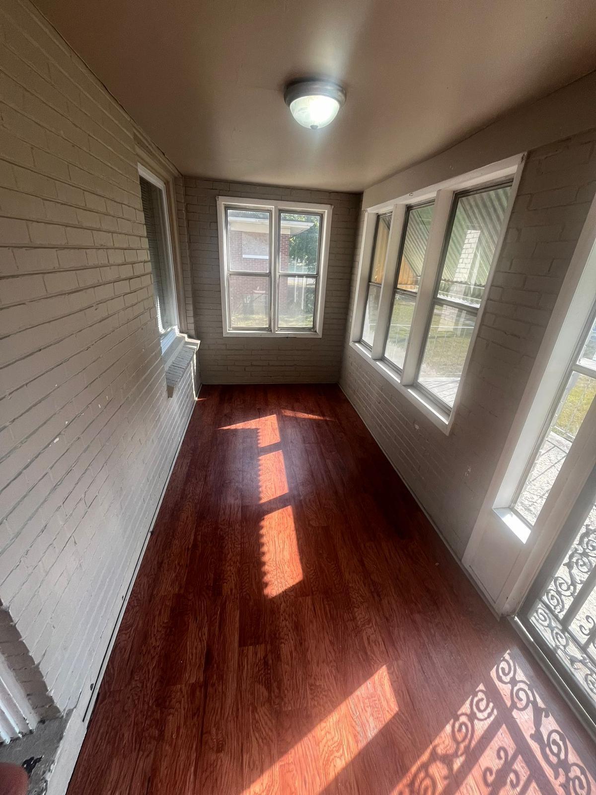 769 Buchanan Street Gary, IN 46402 - Photo 17 of 28 a view of an empty room with wooden floor and a window